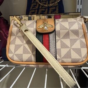 Checkered white and grey mini pouch with a wristlet